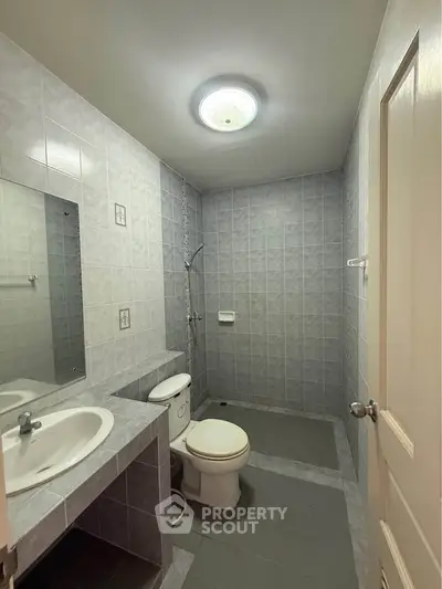 Modern bathroom with sleek gray tiles and contemporary fixtures