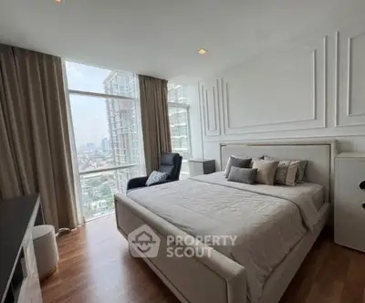 Luxurious bedroom with city view in modern high-rise apartment