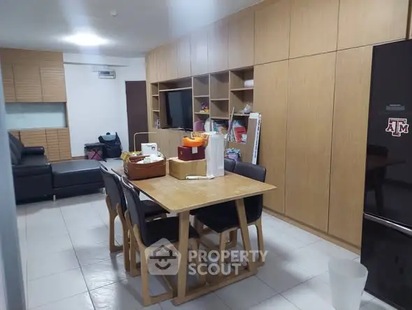 Spacious dining area with wooden cabinetry and modern furniture in a cozy apartment.