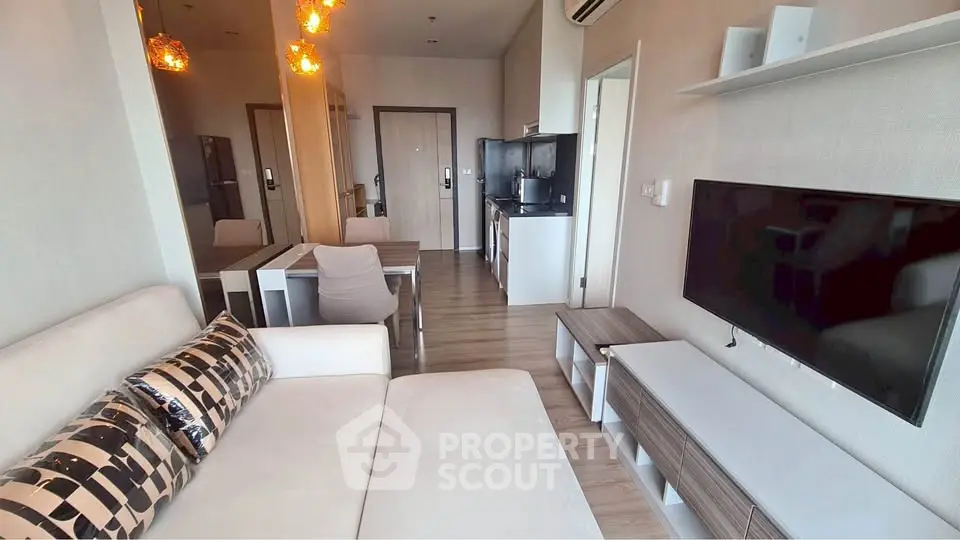 Modern living room with stylish decor and open kitchen layout in a contemporary apartment.