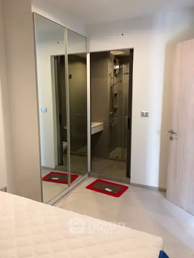 Modern bedroom with mirrored closet and ensuite bathroom