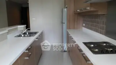 Modern kitchen with sleek cabinetry and electric stove in open layout