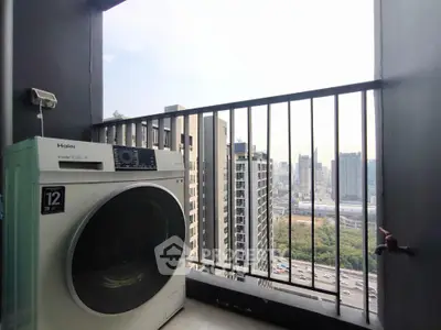 Modern balcony with city view and washing machine, perfect urban living space.