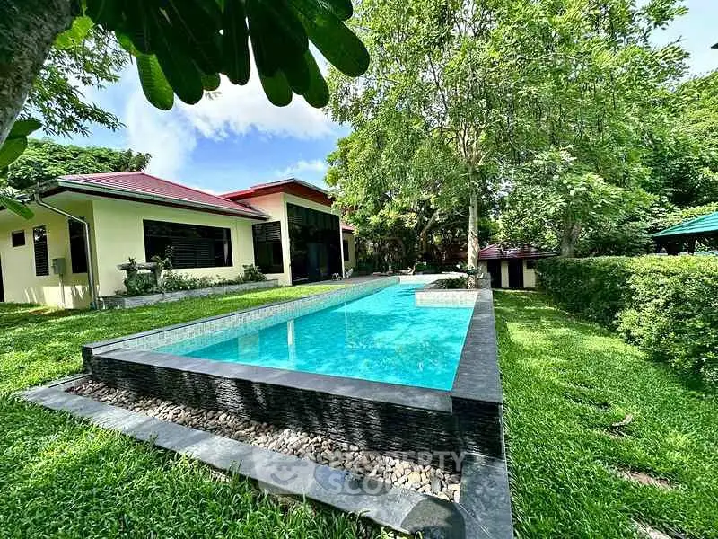 Luxurious home with stunning pool and lush garden, perfect for relaxation and entertaining.