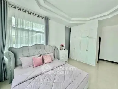 Luxurious bedroom with elegant decor and ample natural light
