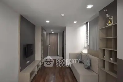 Modern living room with sleek design and cozy seating area, perfect for relaxation and entertainment.
