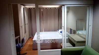 Modern bedroom with sliding glass doors and stylish furniture