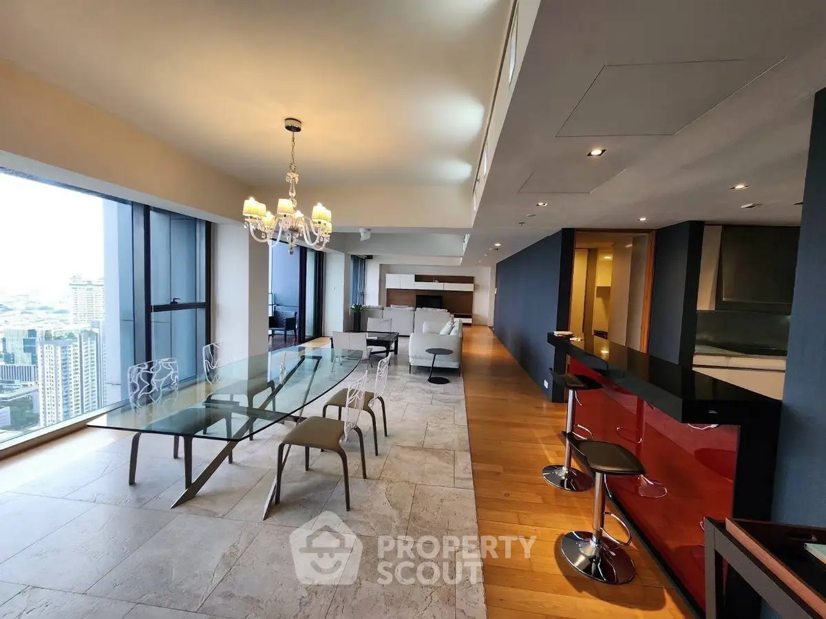 Luxurious open-plan living and dining area with stunning city views and modern decor.