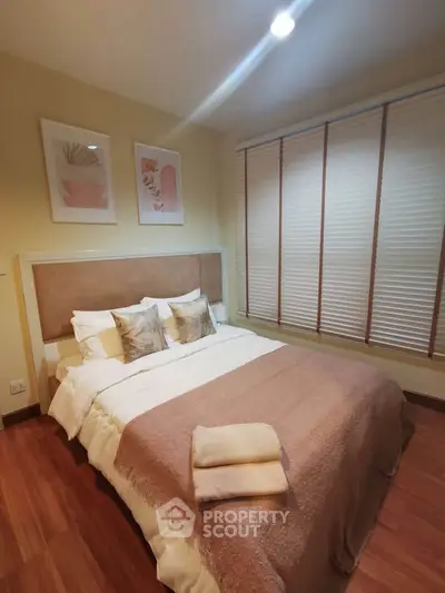 Cozy bedroom with stylish decor and warm lighting in modern apartment
