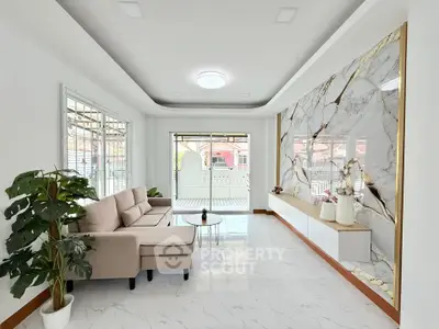 Elegant living room with marble accent wall and cozy seating area