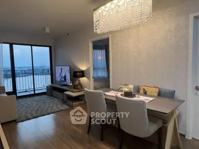 Stylish living room with dining area and balcony view in modern apartment