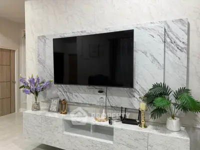 Luxurious living room with marble TV wall and elegant decor