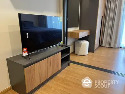 Modern bedroom with sleek TV stand and cozy decor