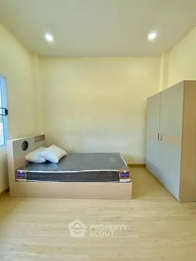 Spacious bedroom with modern minimalist design and ample natural light