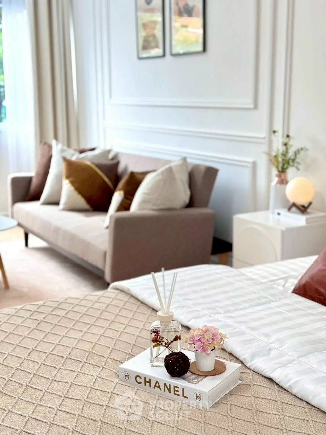 Stylish bedroom with elegant decor and cozy seating area, perfect for relaxation.