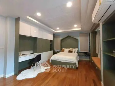 Spacious bedroom with modern design, featuring built-in desk and ample storage, perfect for comfort and functionality.