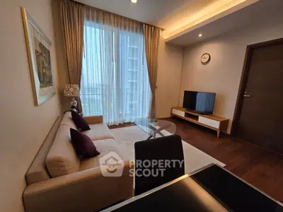 Modern living room with elegant decor, large window, and cozy seating area in a stylish apartment.