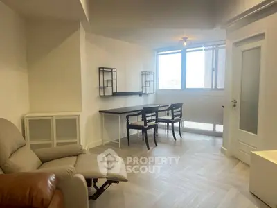 Modern living room with elegant dining area and natural light