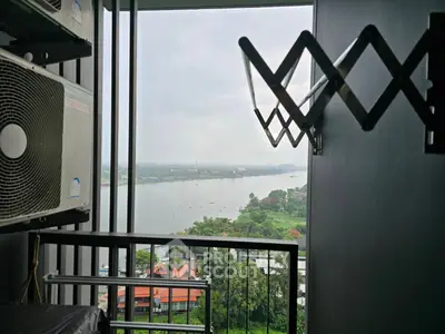 Stunning river view from high-rise balcony with air conditioning unit