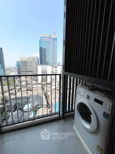 High-rise balcony with city view and washing machine