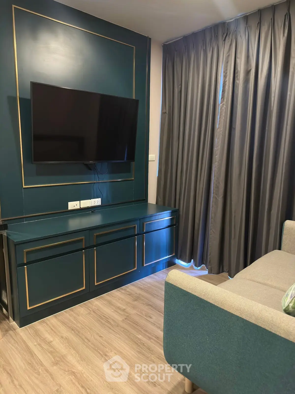 Modern living room with stylish TV setup and elegant curtains