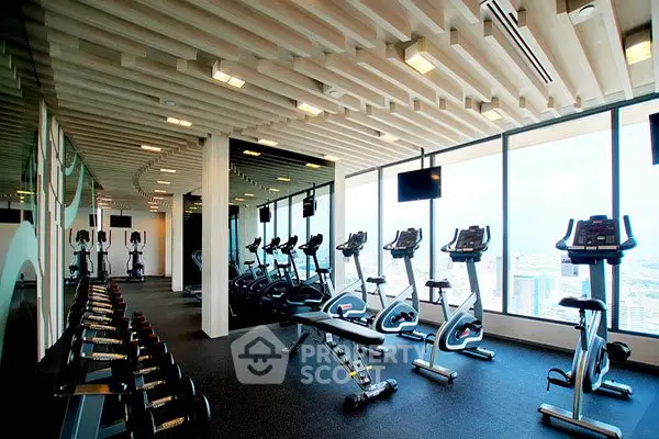 Modern gym with city view in luxury high-rise building