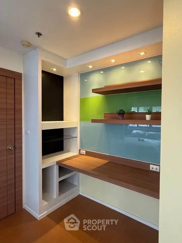 Modern study nook with built-in shelves and colorful accent wall