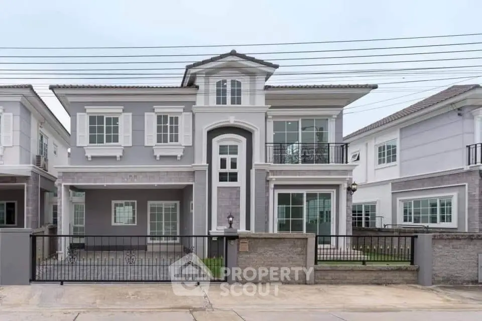 Elegant two-story house with modern design and spacious front yard in a suburban neighborhood.
