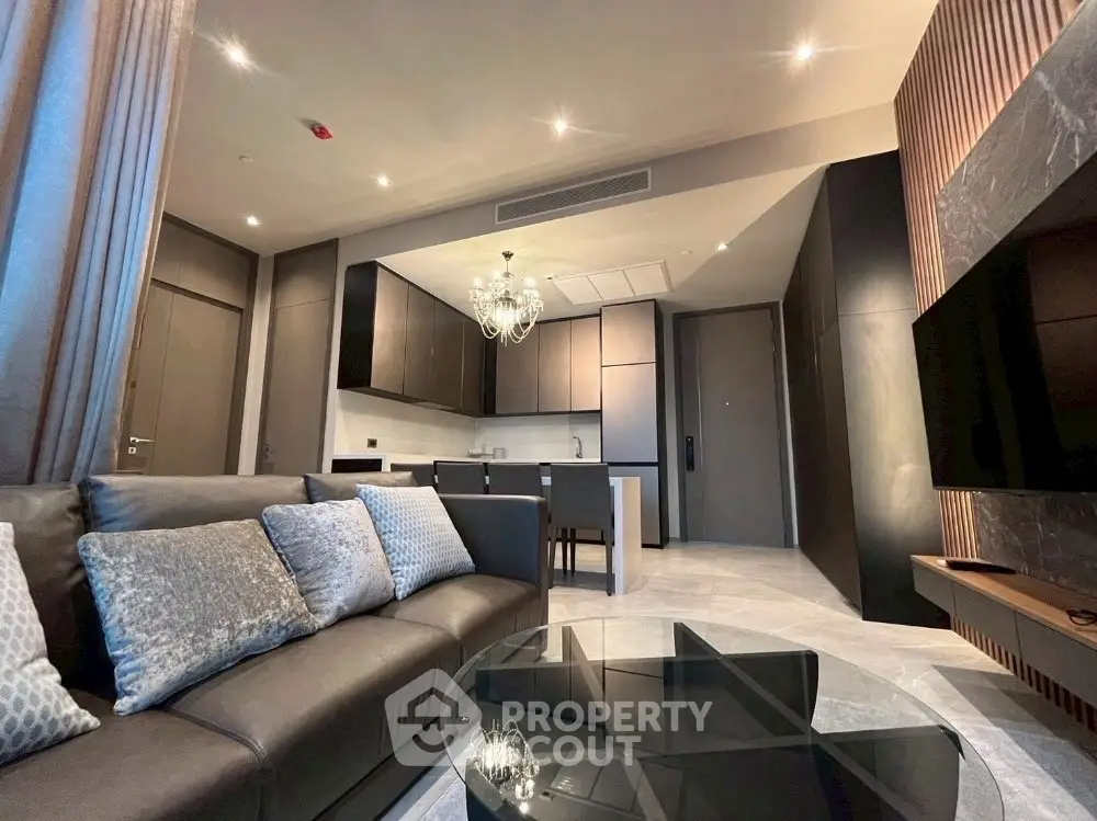 Luxurious modern living room with elegant decor and open kitchen layout, perfect for stylish urban living.