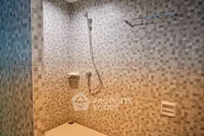 Modern bathroom with tiled walls and shower area