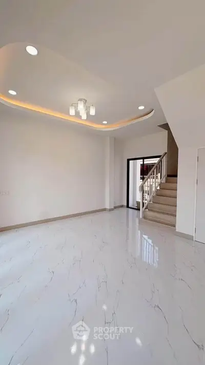 Spacious modern living room with elegant ceiling lights and marble flooring