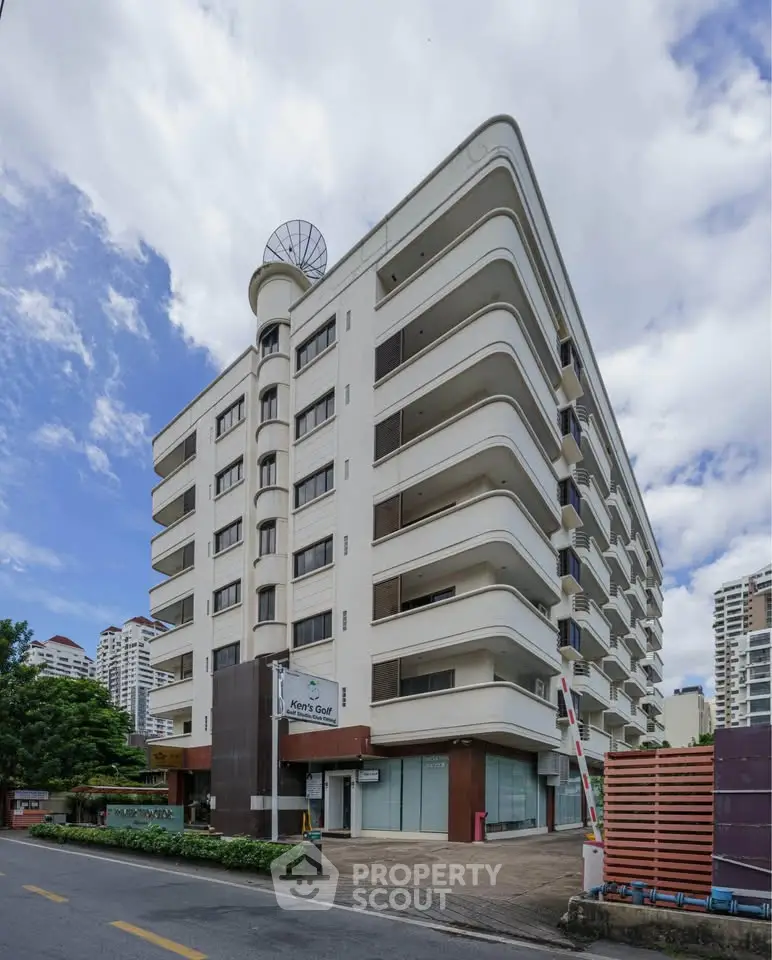 Modern multi-story residential building with unique architectural design and spacious balconies.
