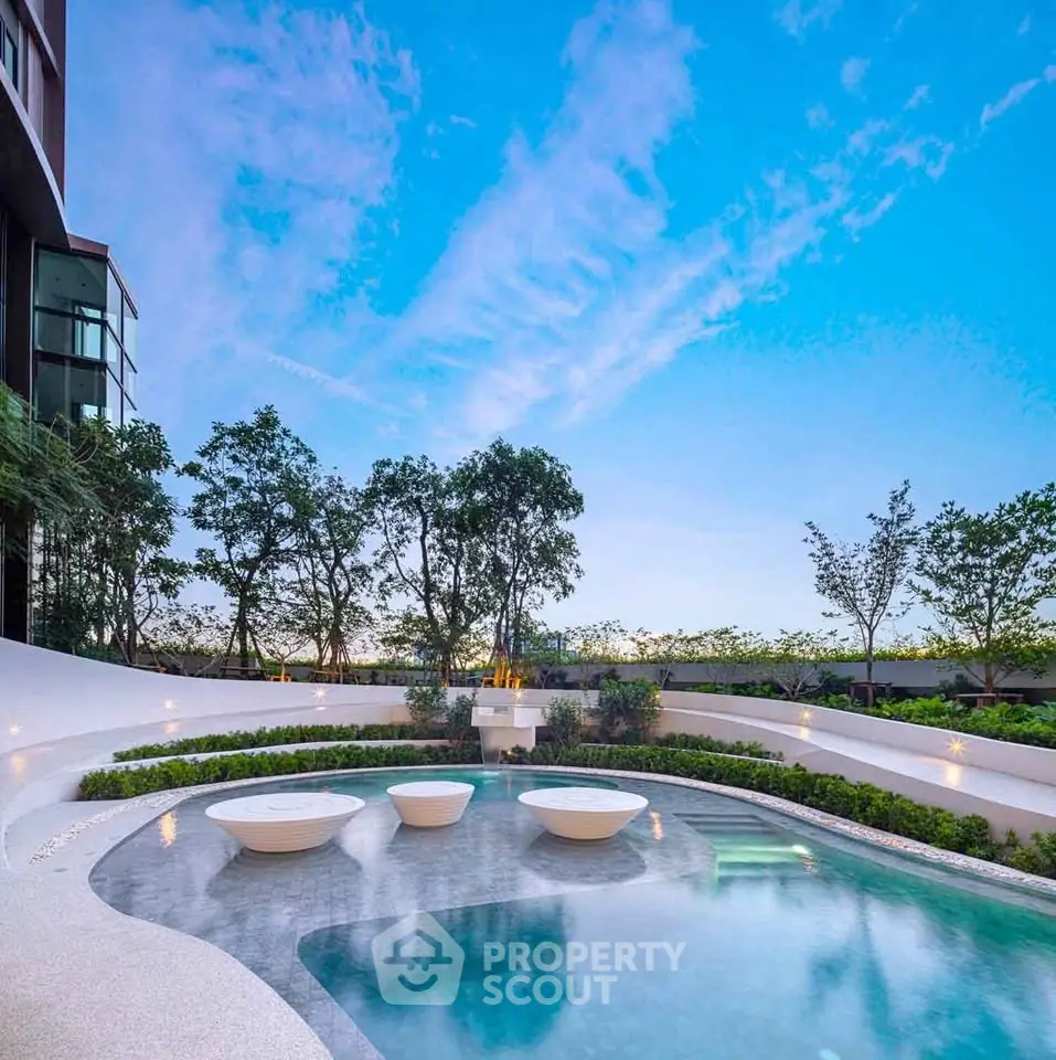 Luxurious outdoor pool with modern design and lush greenery, perfect for relaxation and leisure.