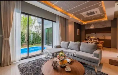 Luxurious living room with pool view, modern furniture, and open kitchen layout.
