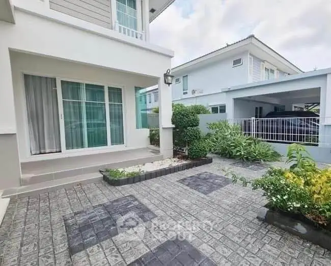 Charming modern home exterior with landscaped garden and spacious driveway.