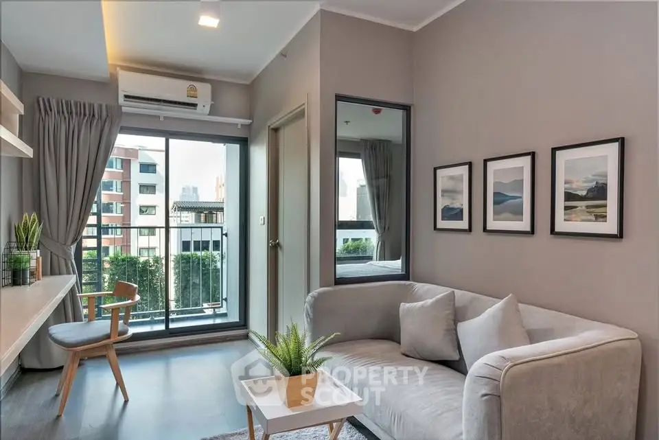 Modern living room with balcony view, stylish decor, and natural light in urban apartment.