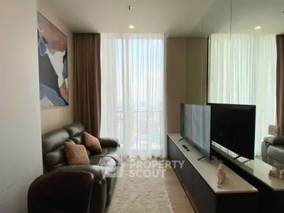 Stylish living room with modern decor and large window offering natural light and city views.