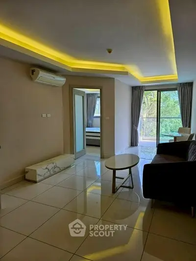 Modern living room with sleek design and natural light, featuring a balcony view.