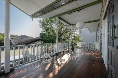 Charming riverside balcony with wooden flooring and scenic views, perfect for relaxation and outdoor enjoyment.
