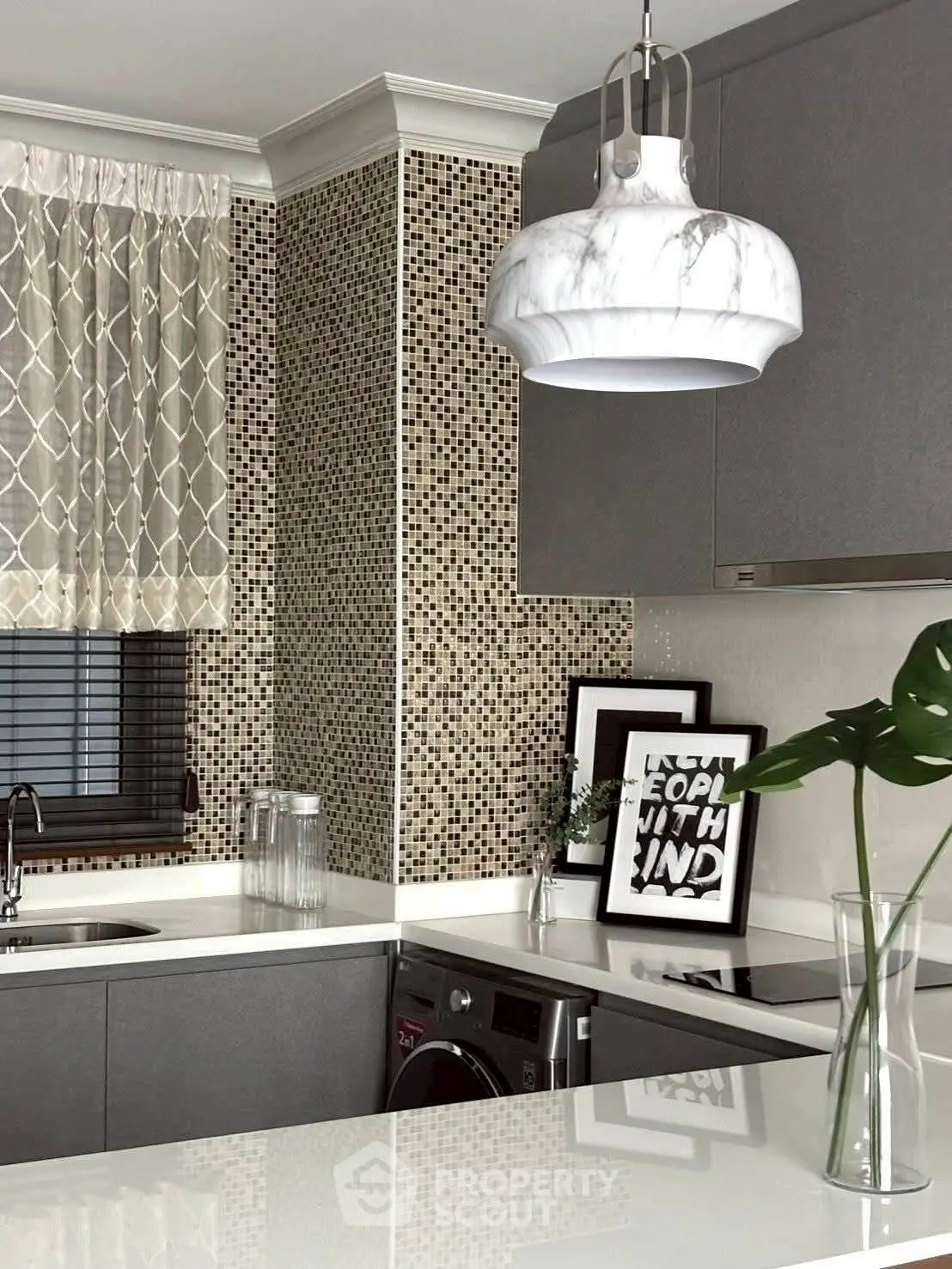Modern kitchen with sleek cabinetry, stylish backsplash, and elegant pendant lighting.