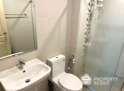 Modern bathroom with glass shower and sleek fixtures in a contemporary home.