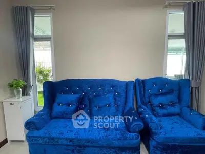 Elegant living room with plush blue sofas and modern decor