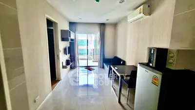 Modern living room with balcony access, sleek furniture, and natural light.