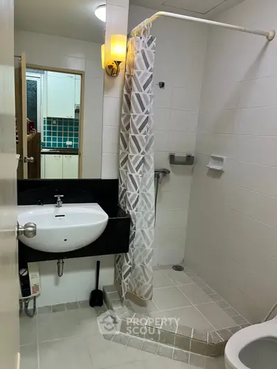 Modern bathroom with shower curtain and sleek sink design