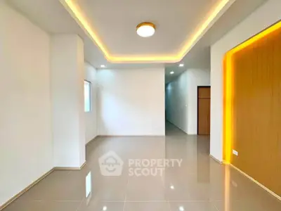 Modern living room with sleek lighting and glossy tile flooring