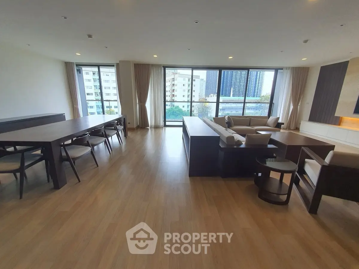 Spacious modern living room with large windows and elegant furniture