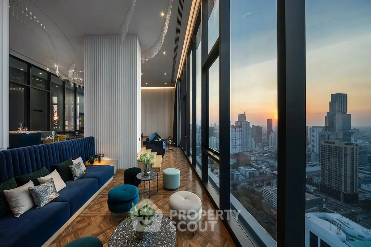 Luxurious high-rise living room with stunning cityscape view at sunset.