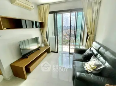 Modern living room with city view, sleek furniture, and large windows for natural light.