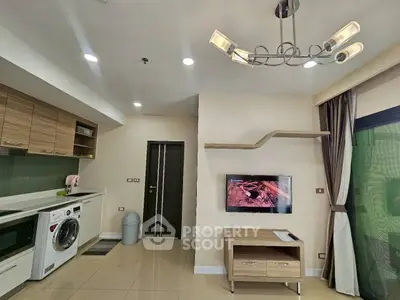 Modern living room with stylish lighting and integrated kitchen appliances