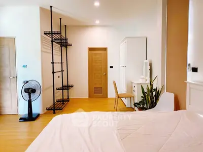 Spacious bedroom with modern decor and natural light